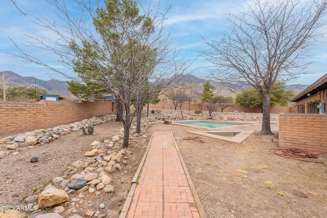 view of yard with a mountain view and a fenced in pool