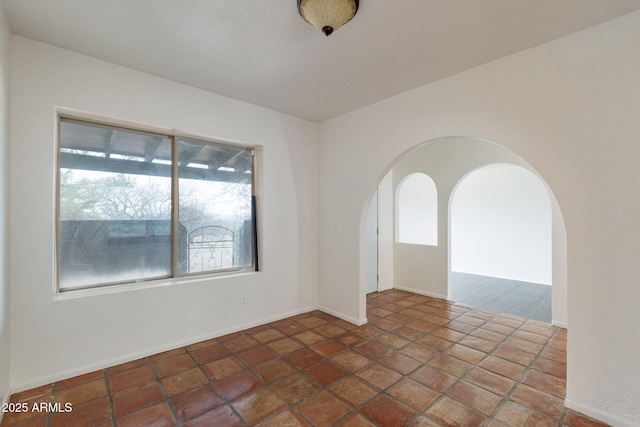 unfurnished room featuring a wealth of natural light