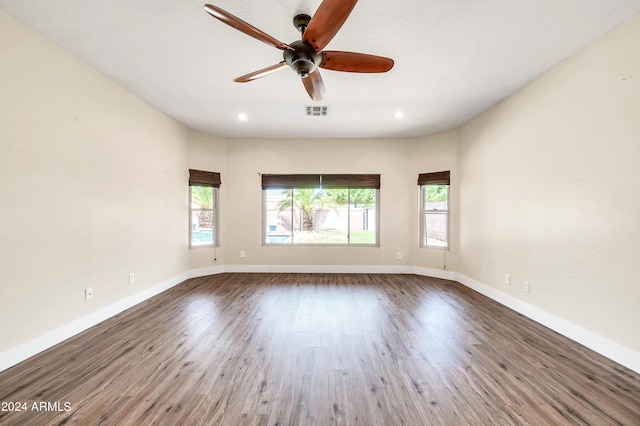 unfurnished room with dark hardwood / wood-style floors and ceiling fan