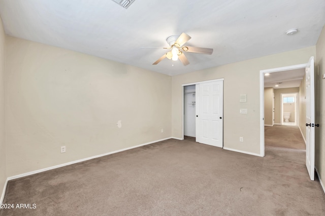 unfurnished bedroom featuring ceiling fan, a closet, and dark colored carpet