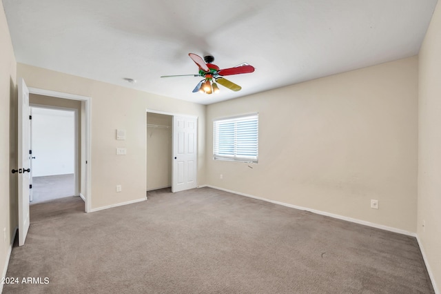 unfurnished bedroom with carpet, ceiling fan, and a closet