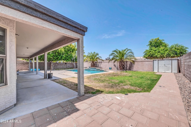 view of yard with a fenced in pool and a patio area