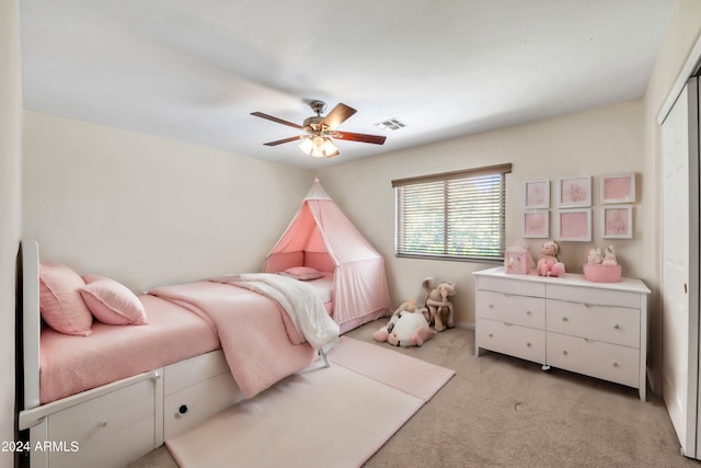 carpeted bedroom featuring a closet and ceiling fan