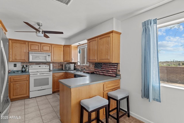 665 W Chaparral Rd, Wickenburg, AZ 85390 - kitchen featuring white appliances, plenty of natural light, and decorative backsplash