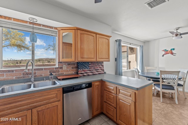665 W Chaparral Rd, Wickenburg, AZ 85390 - kitchen with stainless steel dishwasher, a sink, a ceiling fan, a peninsula, and light tile patterned floors