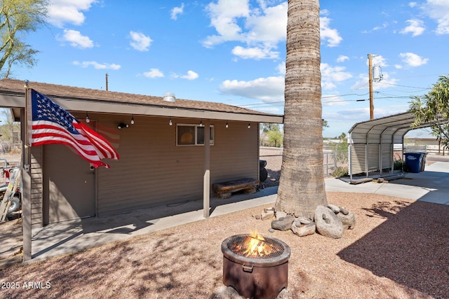 665 W Chaparral Rd, Wickenburg, AZ 85390 - view of side of property with an outdoor fire pit