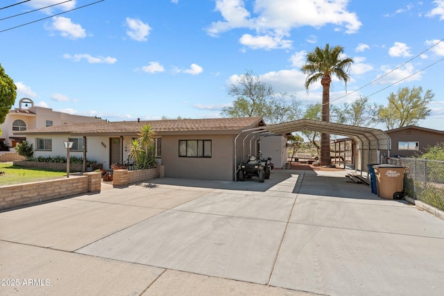 665 W Chaparral Rd, Wickenburg, AZ 85390 - view of front facade featuring a carport, concrete driveway, and stucco siding