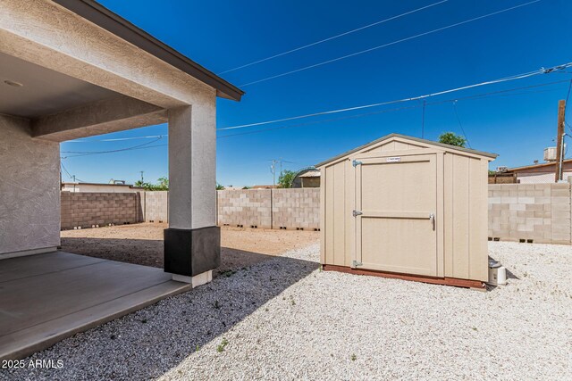 32102 N Walnut St, Wittmann, AZ 85361 - view of patio with a storage shed, a fenced backyard, and an outdoor structure