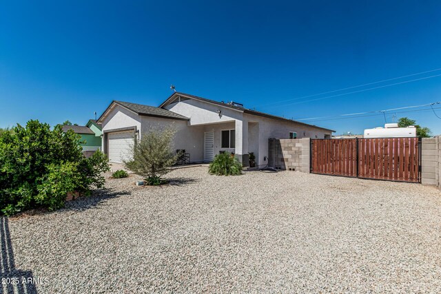 32102 N Walnut St, Wittmann, AZ 85361 - view of front of property with stucco siding, an attached garage, a gate, and fence