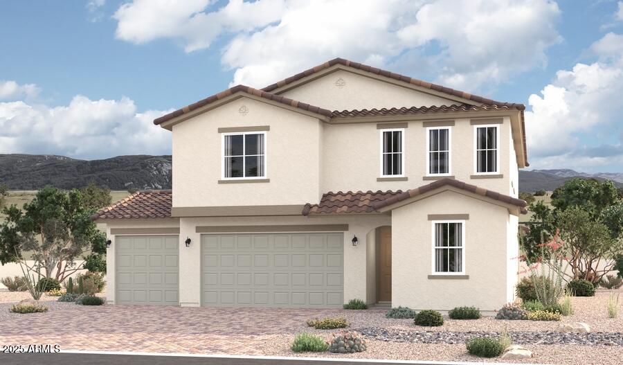 mediterranean / spanish house featuring a mountain view, a tiled roof, stucco siding, and driveway