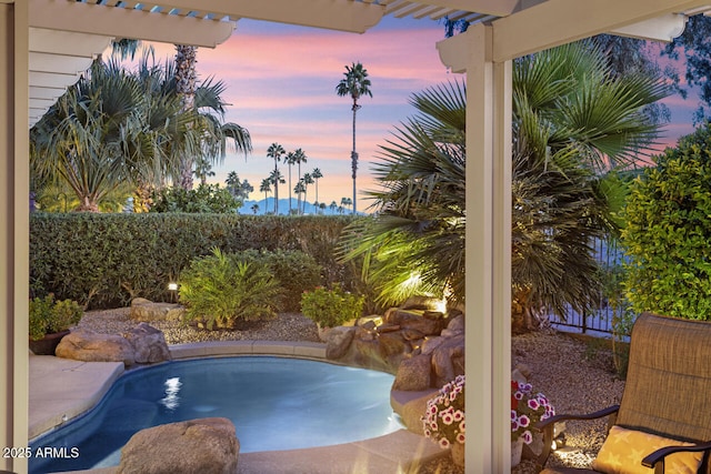 view of pool at dusk