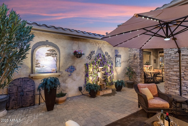 view of patio terrace at dusk