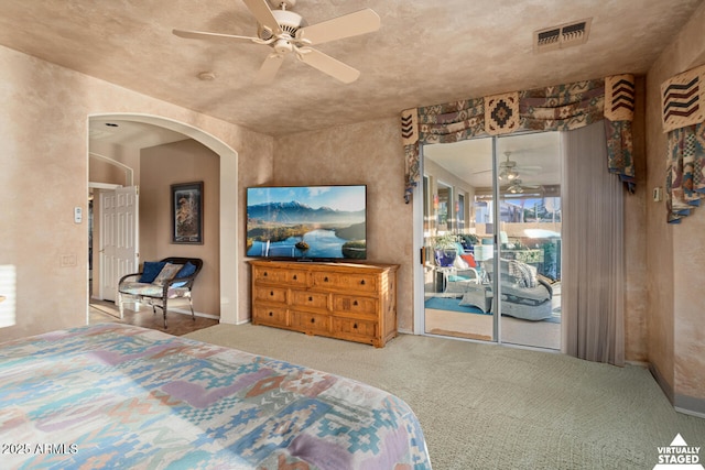 carpeted bedroom featuring access to exterior and ceiling fan