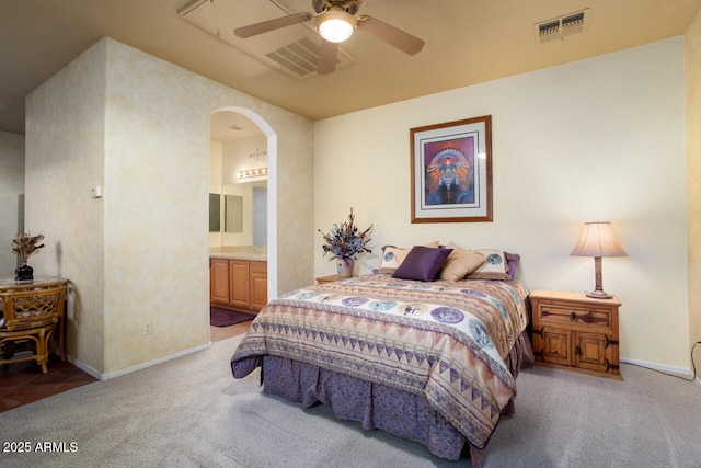 carpeted bedroom featuring ceiling fan and ensuite bath