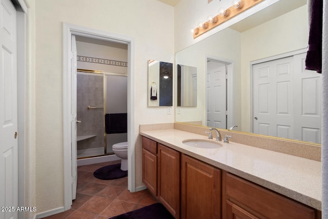 bathroom featuring a shower with door, tile patterned flooring, vanity, and toilet