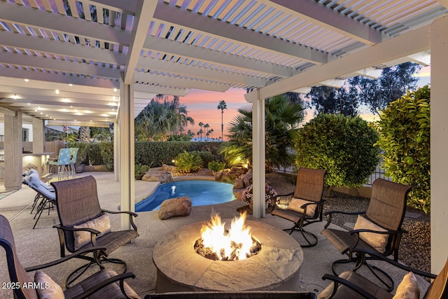 patio terrace at dusk with an outdoor fire pit, a pergola, and a fenced in pool