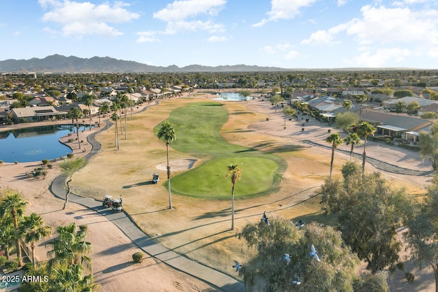 birds eye view of property with a water and mountain view