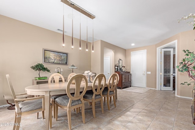 dining area featuring baseboards and light tile patterned floors