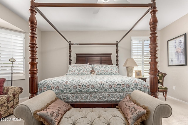 carpeted bedroom with baseboards and ceiling fan