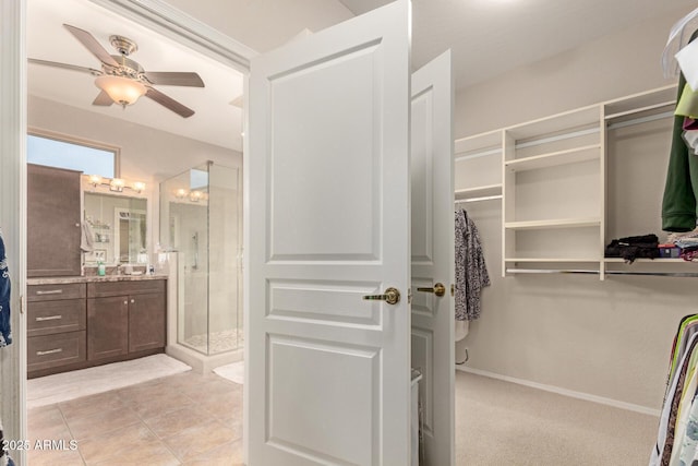 spacious closet featuring ceiling fan