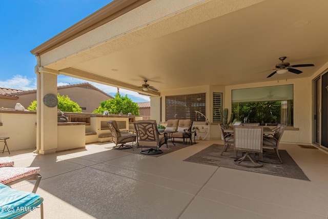 view of patio / terrace featuring a ceiling fan, outdoor dining space, an outdoor living space, and exterior kitchen