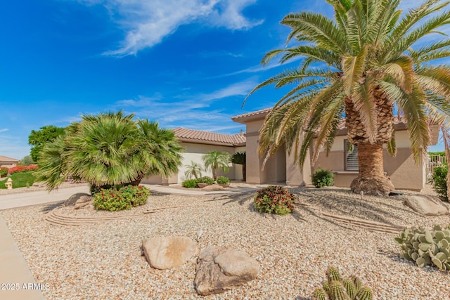mediterranean / spanish-style house featuring a tiled roof and stucco siding