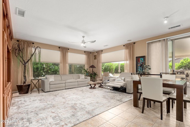 living area with ceiling fan, light tile patterned flooring, and visible vents