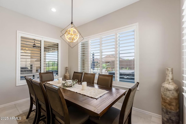 dining space with baseboards, recessed lighting, and a chandelier