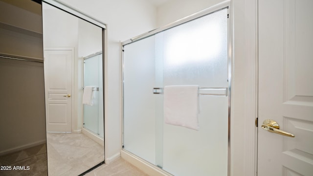 bathroom featuring a shower with door