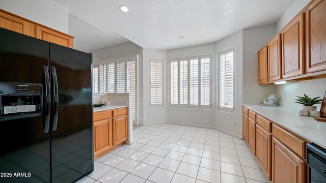 kitchen with black appliances and light tile patterned floors