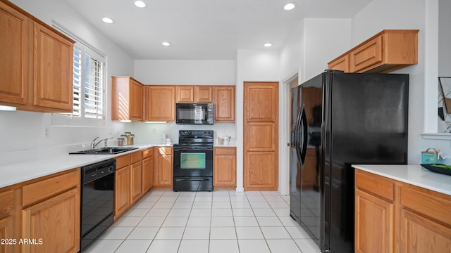 kitchen featuring light tile patterned flooring, sink, and black appliances