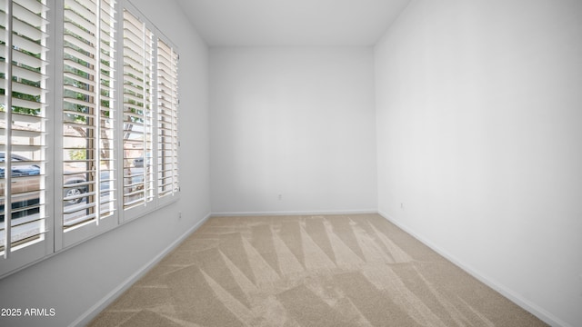 unfurnished room with light carpet