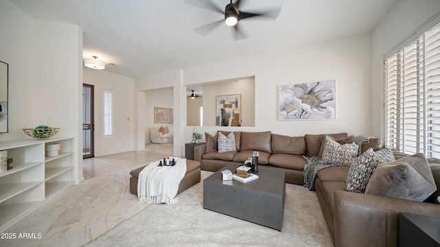 living room with ceiling fan and light tile patterned flooring