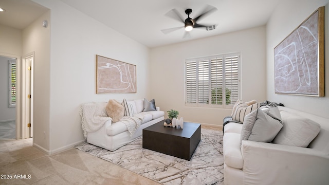 living room featuring ceiling fan and light colored carpet