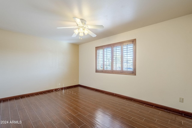 empty room featuring dark hardwood / wood-style floors and ceiling fan