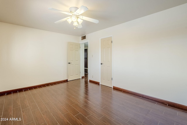 spare room featuring ceiling fan and dark wood-type flooring