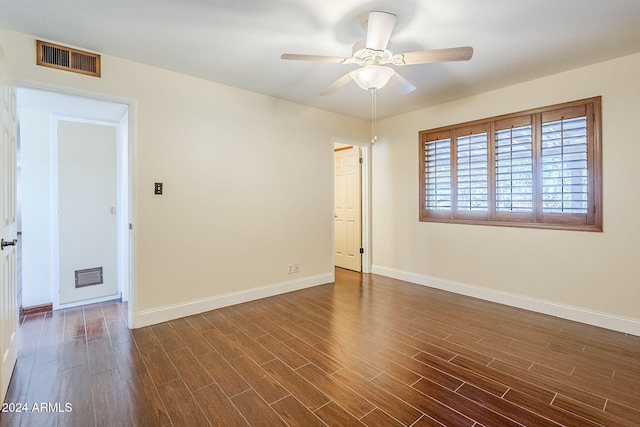 unfurnished room featuring ceiling fan and dark hardwood / wood-style flooring