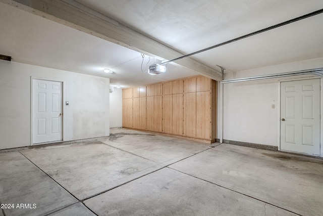 garage featuring wooden walls and a garage door opener