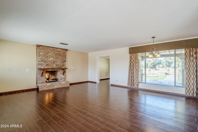 unfurnished living room with a fireplace and an inviting chandelier