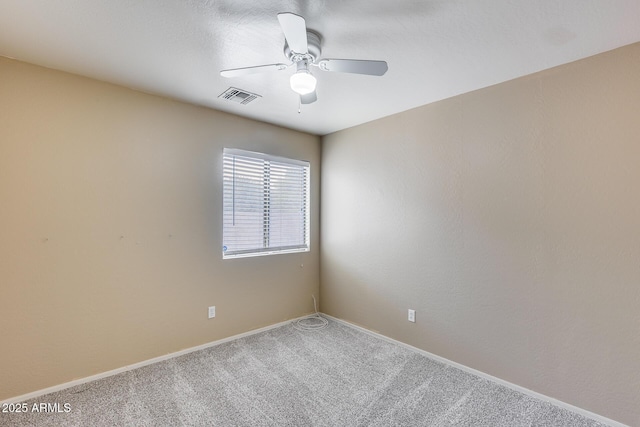 spare room with visible vents, baseboards, a ceiling fan, and carpet flooring