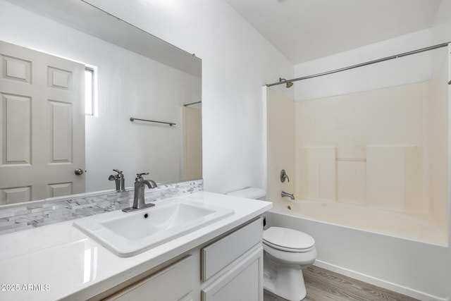 full bathroom with vanity, toilet, wood finished floors, and shower / bathtub combination