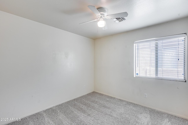 unfurnished room featuring light carpet, baseboards, and a ceiling fan