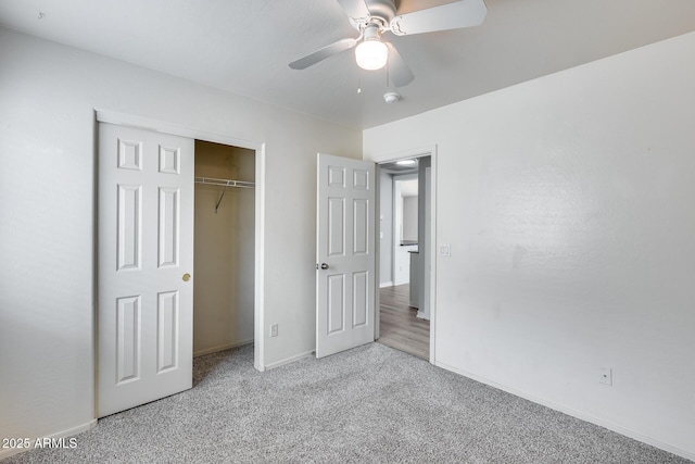 unfurnished bedroom with a closet, baseboards, a ceiling fan, and carpet flooring