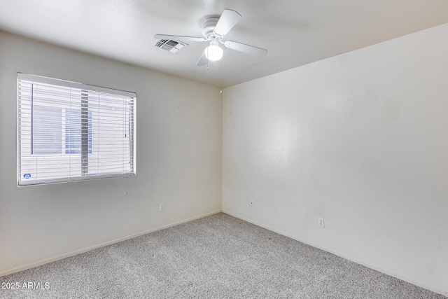 spare room featuring visible vents, baseboards, carpet flooring, and a ceiling fan