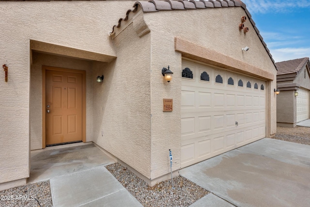 property entrance featuring stucco siding and a tile roof