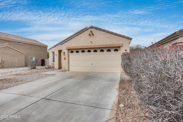 view of front of property featuring stucco siding, concrete driveway, and a garage