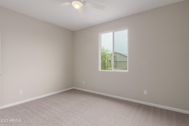 empty room with ceiling fan and light colored carpet