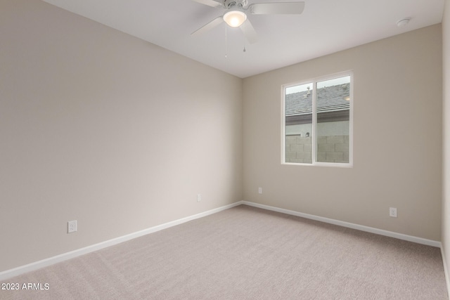 empty room featuring ceiling fan and light carpet