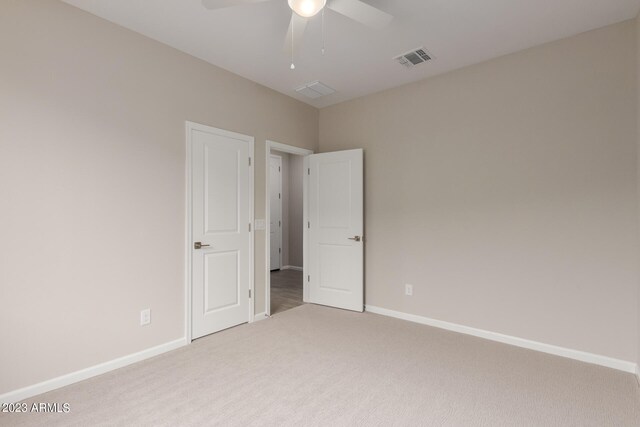 unfurnished room with ceiling fan and carpet floors