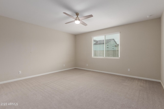 unfurnished room with ceiling fan and light carpet